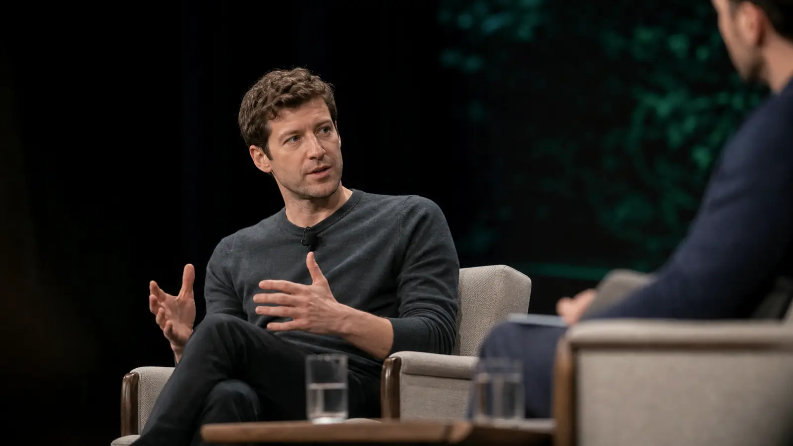 Andrej Karpathy seated on a stage in conversation at Sequoia AI Ascent 2026, microphone clipped to his shirt